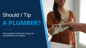 Illustrating blog post “Should I Tip a Plumber?” is an image of a woman out-of-focus on the background reaching her hand holding cash towards a plumber’s hand in the foreground.