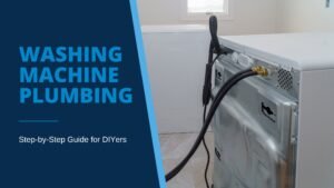 Photo of the back of a white washing machine with black water and drain hoses extending out and into washing machine plumbing hookups.