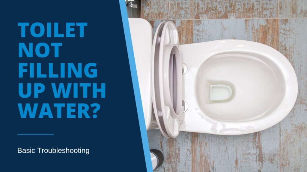White porcelain toilet on blue tile floor with very little water in toilet bowl, illustrating blog post “Toilet Not Filling Up With Water? Basic Troubleshooting.”
